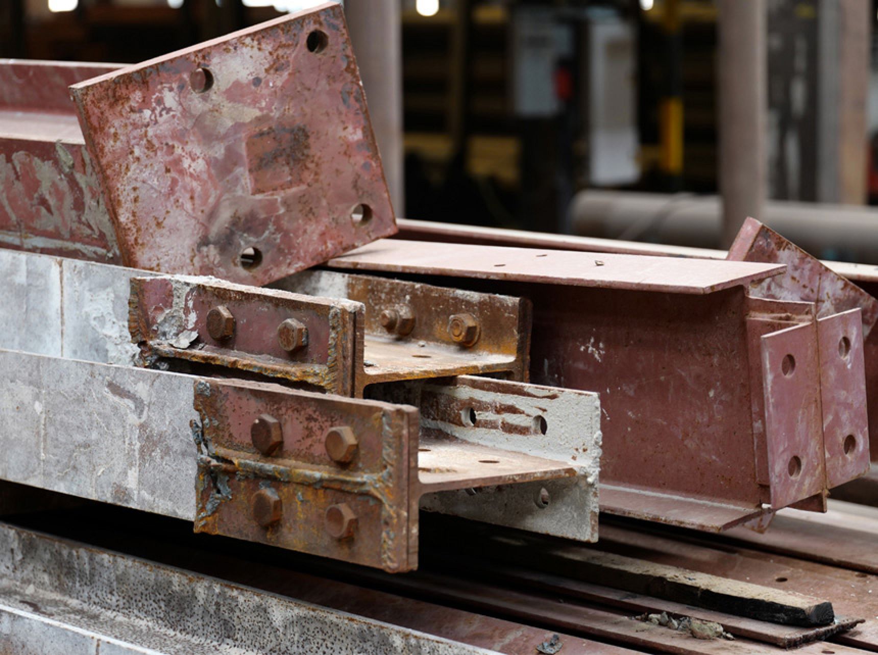 Reclaimed steel beams being prepared for reuse in a circular economy construction project.